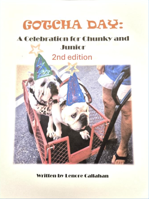 two bulldogs wearing party hats and sitting in a wagon